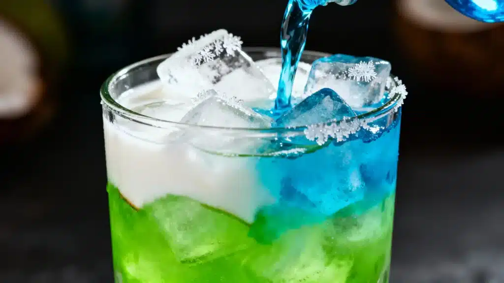 pouring Midori coconut rum blue curaçao into glass with ice for liquid maria juana drink