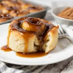 Pioneer-Womans-Cinnamon-Rolls: A Legendary Holiday Tradition 12 Single frosted pioneer-womans-cinnamon-roll on a plate