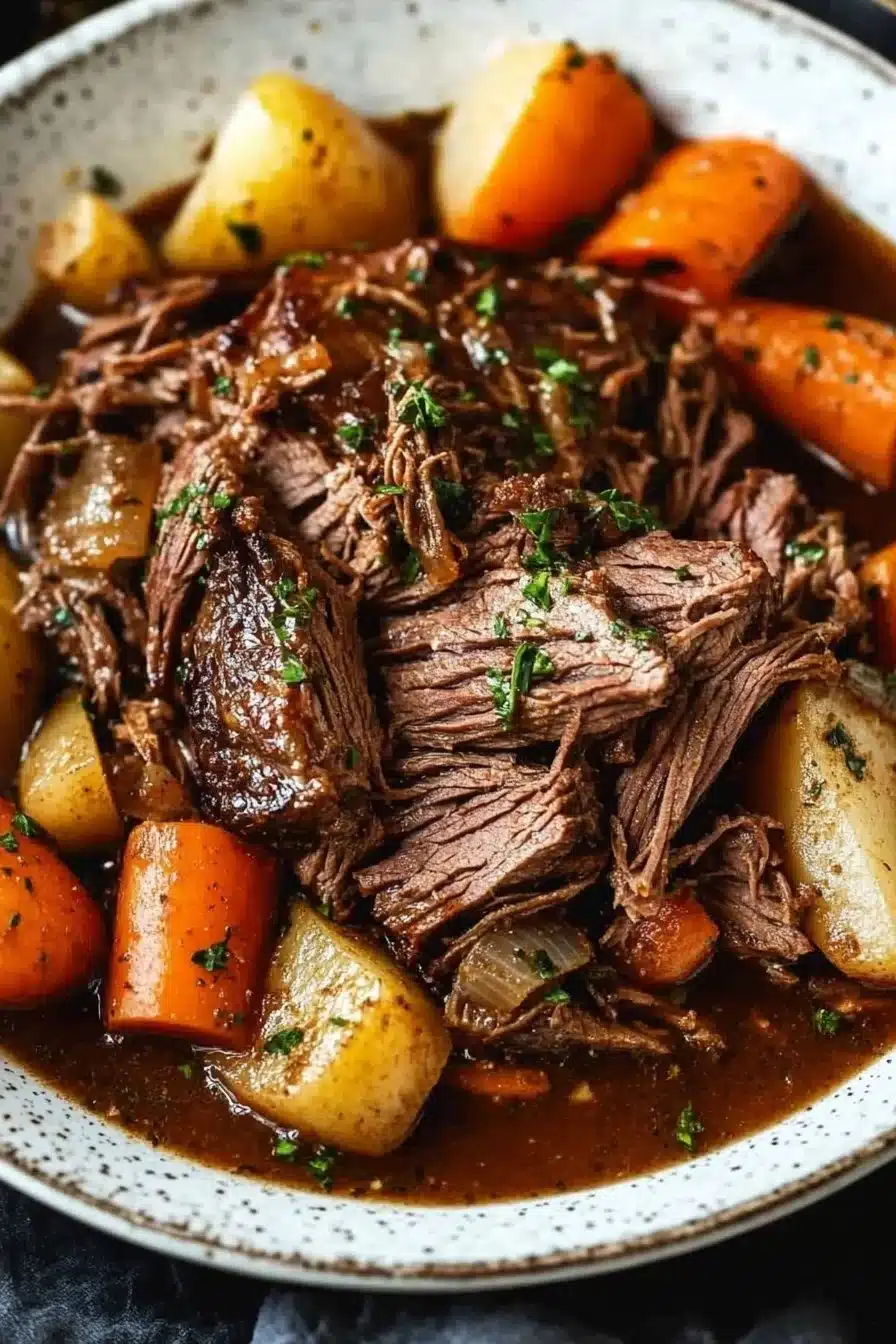 Tender beef roast cooked in a slow cooker with vegetables and herbs