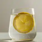 gelatin water trick recipe in clear glass with lemon slice