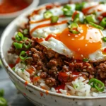 finished boy kibble recipe bowl sriracha drizzle green onion white plate close up