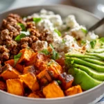 5 Easy Cottage Cheese Beef Bowl Recipes Your Family Will Love 14 Cottage cheese beef bowl being assembled with beef sweet potato and avocado layers in white bowl