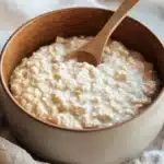 Bowl of simple and delicious oatmeal with fresh fruits and nuts