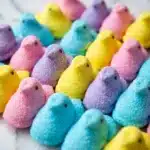 Do peeps have gelatin colorful yellow pink purple peeps marshmallow chicks arranged on white marble surface