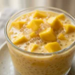 Mango sago recipe served in dessert cups with mango cubes close up